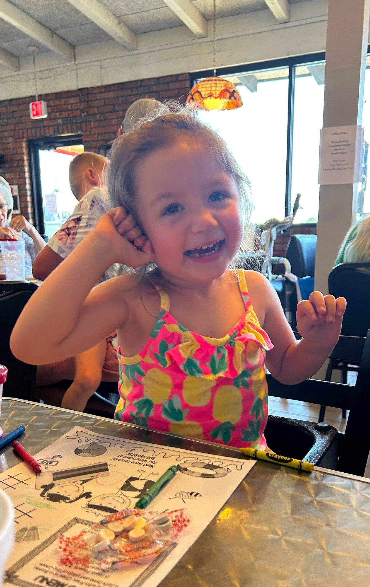 Astrid is registered to the contest to win money with this photo: art, artist, chair, child, community, desk, event, fun, happy, indoor_games_and_sports, joy, leisure, people, person, play, recreation, smile, t_shirt, table, toddler