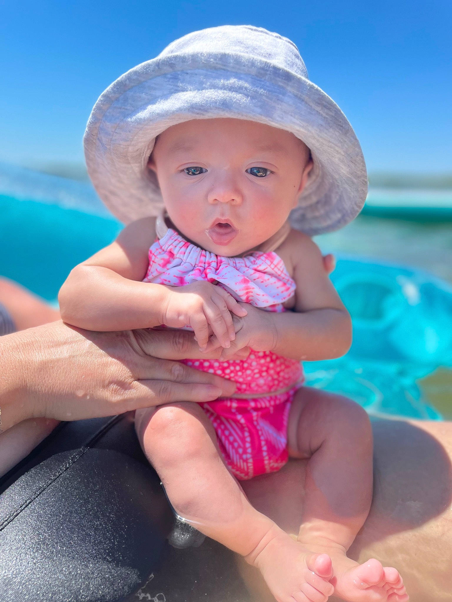 Athena joined the competition — help win amazing prizes! baby, baby_toddler_clothing, barefoot, beauty, blue, child, fun, happy, hat, headwear, human_leg, leg, leisure, person, photograph, pink, skin, sky, summer, sun_hat