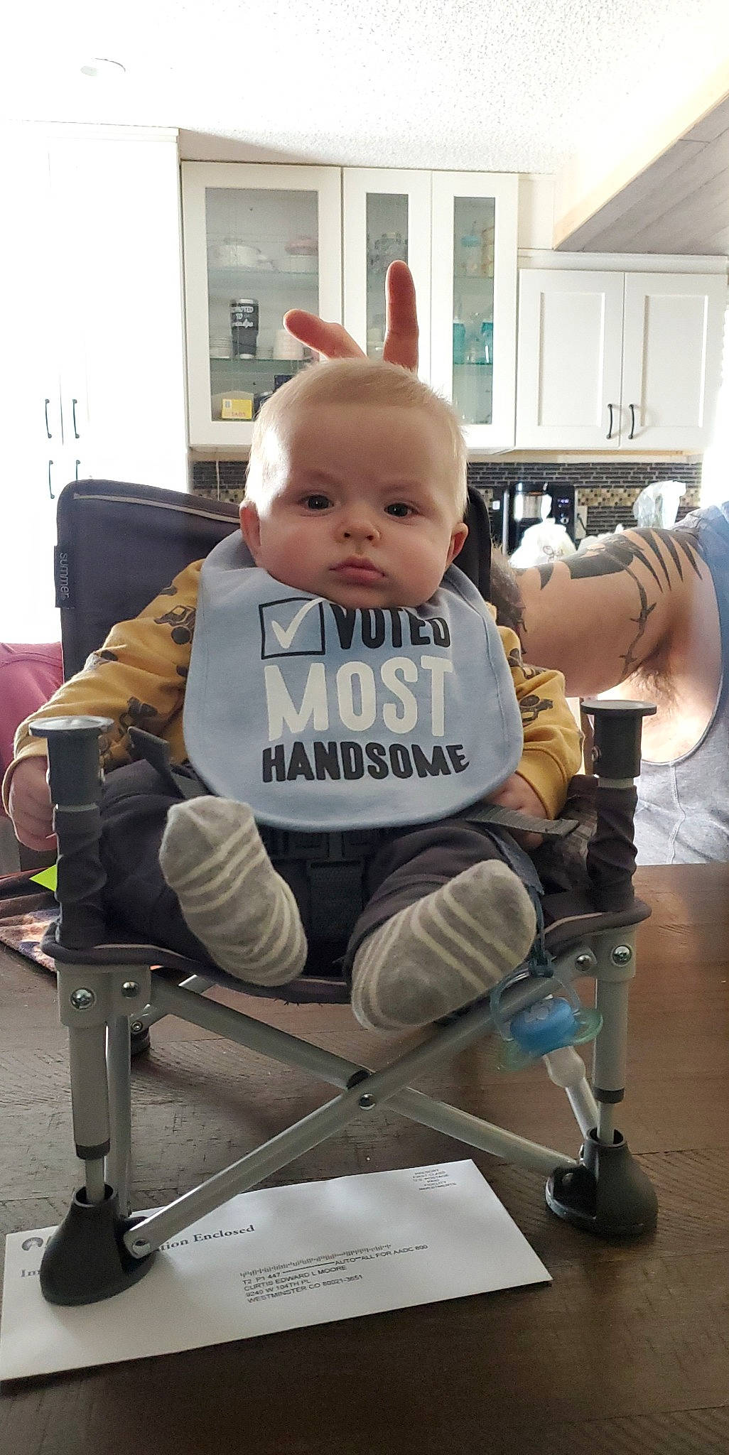 Curtis is registered to the contest to win money with this photo: baby, baby_products, baby_safety, baby_toddler_clothing, chair, child, comfort, fun, furniture, human_leg, knee, machine, office_chair, person, room, service, shorts, sitting, toddler, wheel