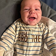Sawyer joined the competition — help win amazing prizes! baby, smiling, onesie, striped_clothing, infant, happy, face, child, blanket, sleepwear, portrait, young_child, cute, indoor, soft_fabric, zipped_clothing, person, closeup, head, wrapped