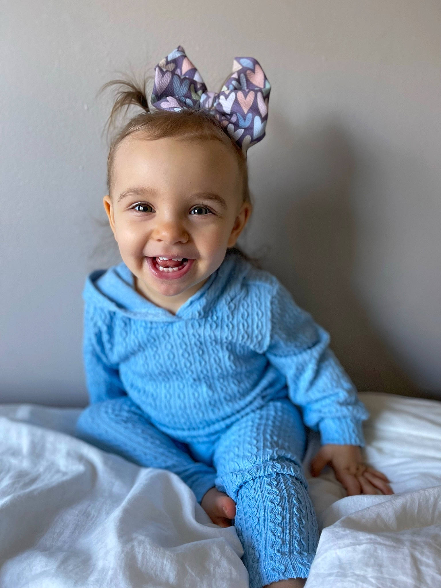 Quinn is registered to the contest to win money with this photo: azure, baby_toddler_clothing, clothing, comfort, dress, electric_blue, eye, facial_expression, hairstyle, happy, headband, headpiece, iris, joy, pattern, person, purple, skin, sleeve, smile