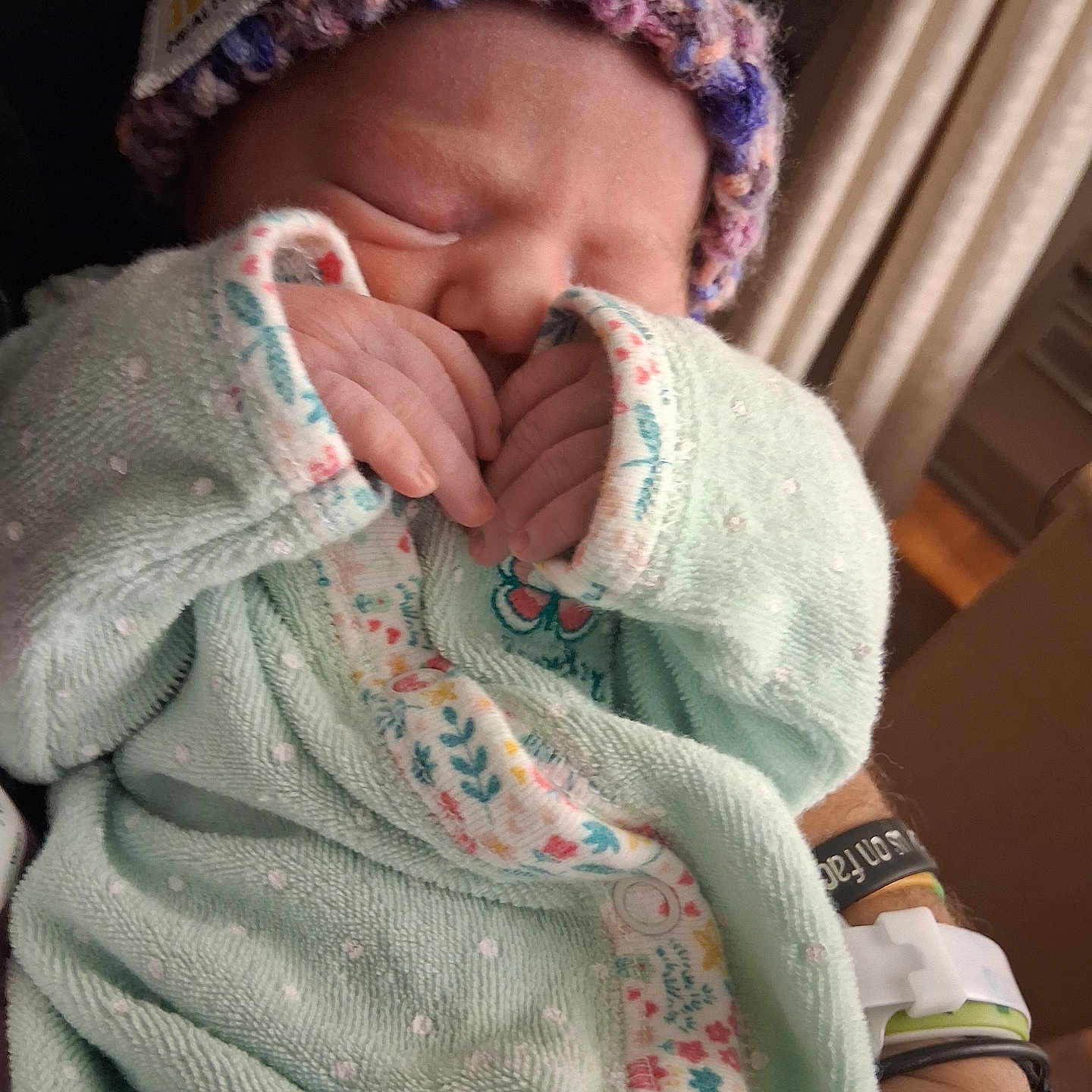 Emiley joined the competition — help win amazing prizes! adult_hand, baby, blanket, closeup, cozy, cute, floral, hand, indoor, infant, knit_hat, newborn, pattern, peaceful, person, resting, sleeping, soft, wearing, wristband