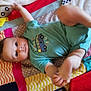 baby, child, infant, blanket, colorful, onesie, clothing, pattern, playful, cute, face, portrait, laying, floor, soft, texture, baby_toys, striped, star_pattern, red