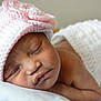 Makayla is registered to the contest to win money with this photo: baby, child, closeup, cozy, crocheted_hat, cute, diaper_cover, face, headwear, indoors, infant, newborn, peaceful, pink, portrait, resting, skin, sleeping, soft_texture, white