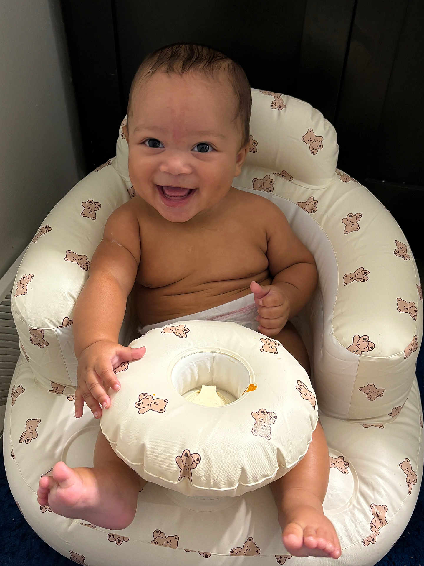 Syaire joined the competition — help win amazing prizes! baby, infant, smile, happy, inflatable_chair, teddy_bear_pattern, child, cute, playful, skin, bare_chest, diaper, sitting, hand, foot, face, indoors, blue_floor, joy, expression