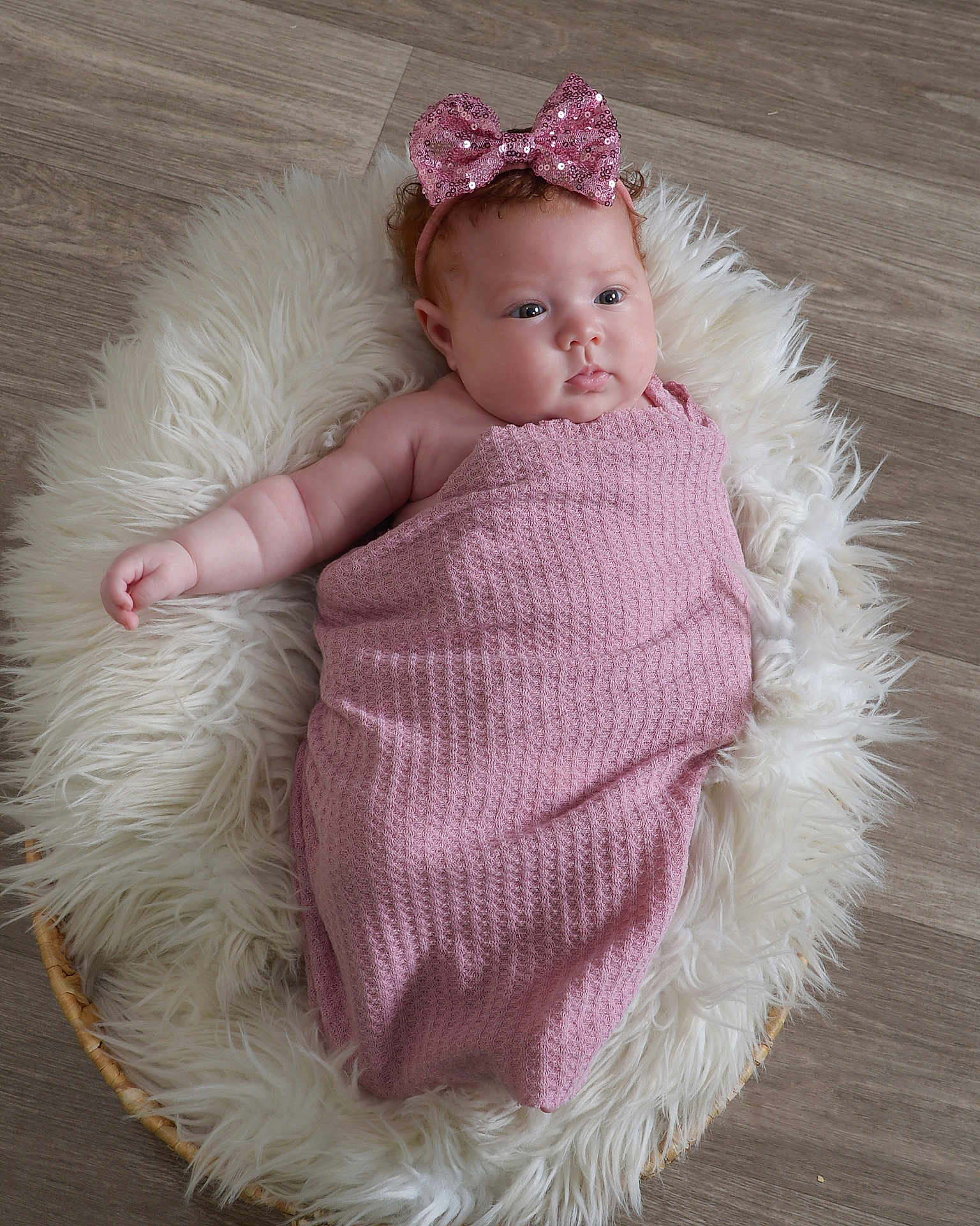 Alaia joined the competition — help win amazing prizes! baby, infant, pink_bow, blanket, fluffy_rug, basket, wooden_floor, headband, cute, chubby_cheeks, wrapped, lying_down, indoors, soft_texture, portrait, closeup, child, adorable, peaceful, small_hand
