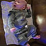 Eric is registered to the contest to win money with this photo: baby, infant, child, towel, couch, sofa, leather, onesie, clothing, face, head, eyes, hands, feet, diaper, blanket, portrait, looking_up, blue_light, cute