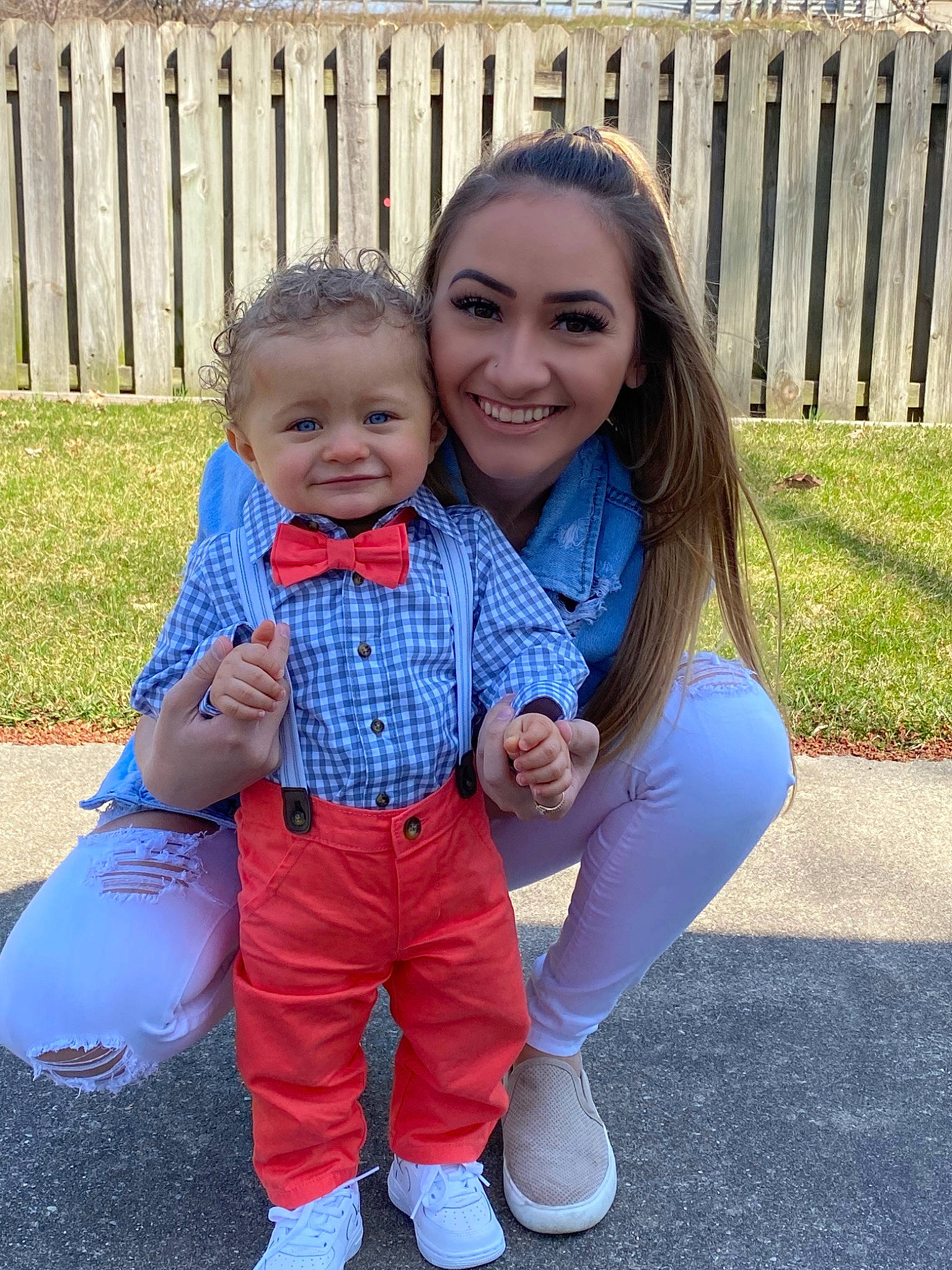 Jessiah is registered to the contest to win money with this photo: azure, baby, baby_toddler_clothing, eye, face, facial_expression, fence, gesture, grass, hair, hairstyle, happy, head, iris, joy, organ, people_in_nature, person, shoe, smile