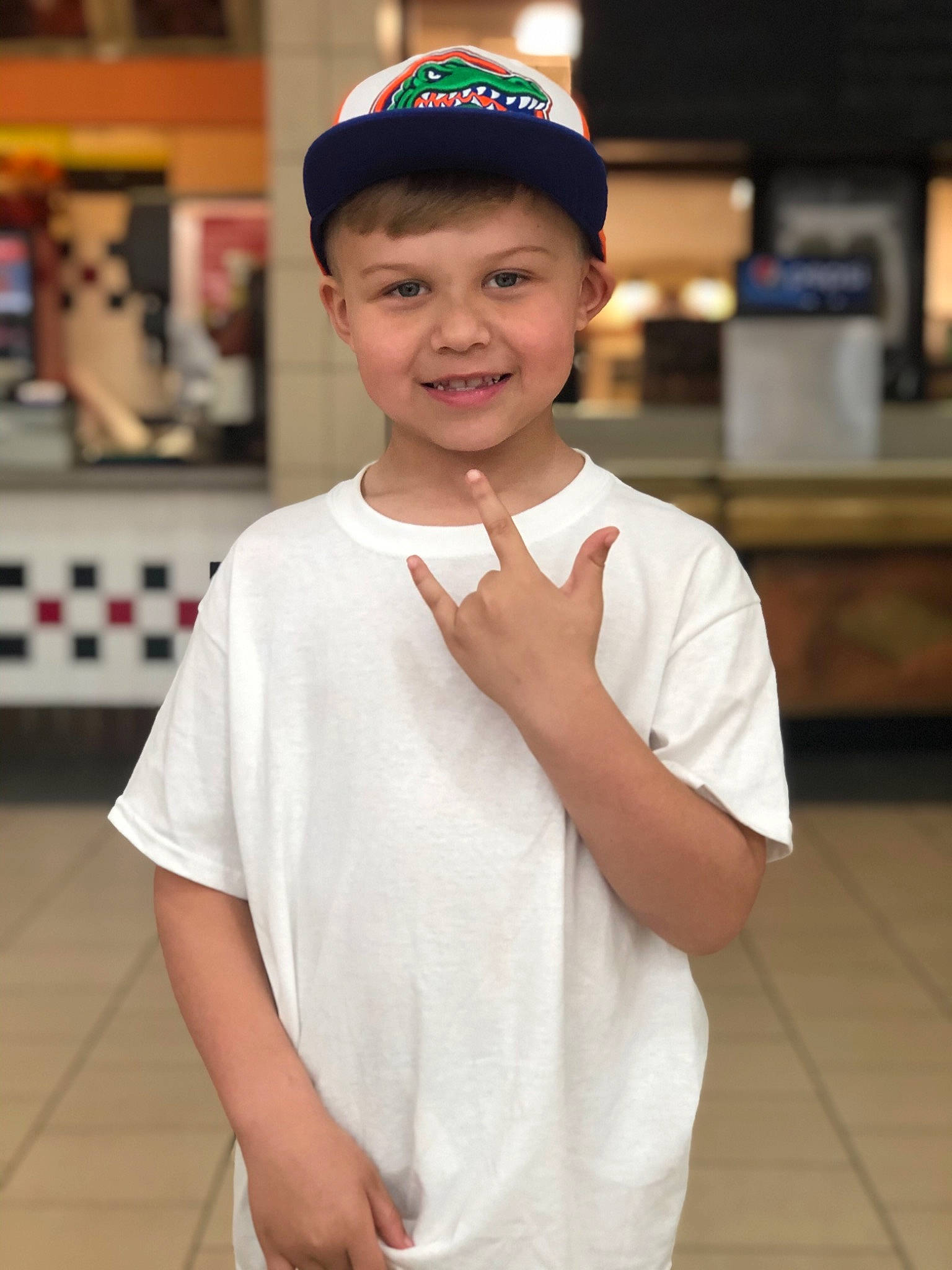 Mason is registered to the contest to win money with this photo: cap, child, fun, headgear, headwear, joy, person, sleeve, smile, uniform