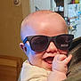 baby, child, sunglasses, smile, happy, indoor, person, face, hand, head, clothing, kitchen, furniture, background, light, skin, cute, newborn, infant, portrait