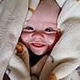 Christian is registered to the contest to win money with this photo: baby, blanket, smile, face, infant, wrapped, soft_texture, cute, child, happy, skin, hand, cozy, indoors, closeup, portrait, eyes, tongue, warm, comfort