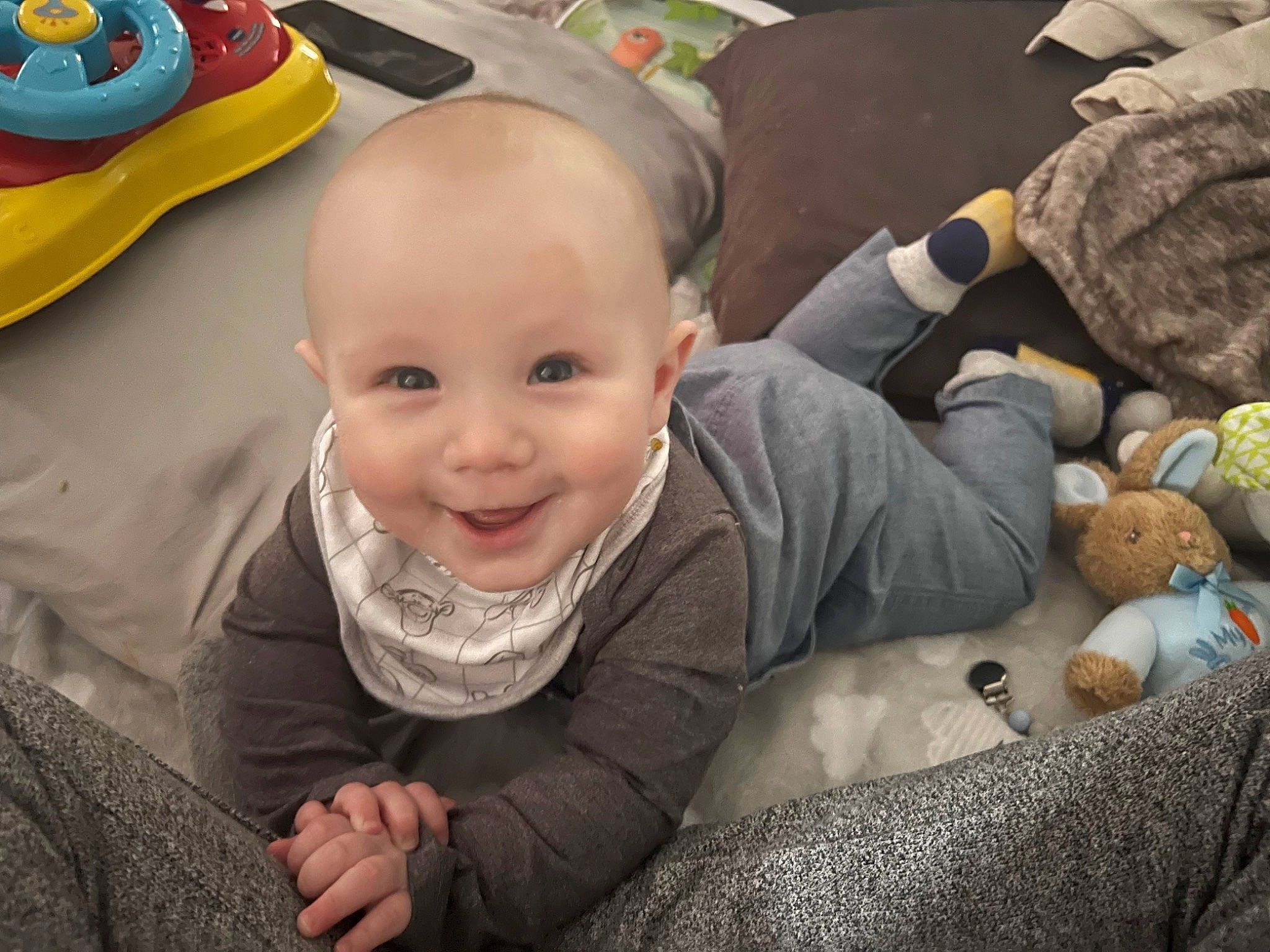 Grayson is registered to the contest to win money with this photo: baby, baby_laughing, baby_toddler_clothing, camouflage, cheek, child, comfort, event, fun, happy, head, human, joy, laugh, military_camouflage, person, room, sitting, skin, smile