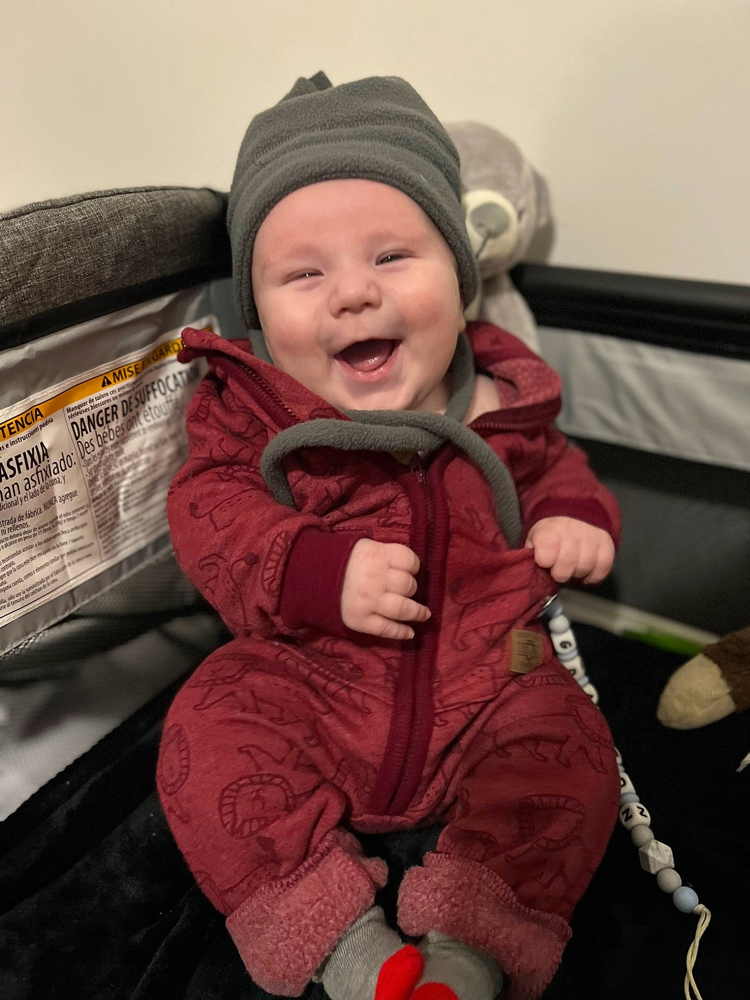 Grayson is registered to the contest to win money with this photo: baby, baby_carriage, baby_toddler_clothing, cap, cheek, child, comfort, eye, facial_expression, fun, happy, headgear, headwear, jacket, lap, outerwear, person, skin, smile, standing