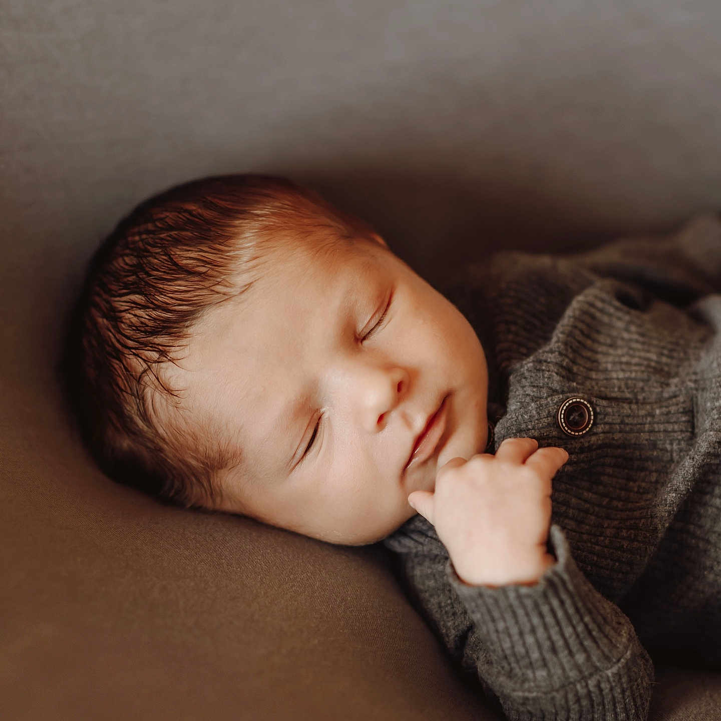 Resyn is registered to the contest to win money with this photo: baby, brown, child, closeup, clothing, comfort, cozy, cute, face, hand, infant, knitwear, newborn, peaceful, portrait, relaxation, rest, sleeping, soft, warm