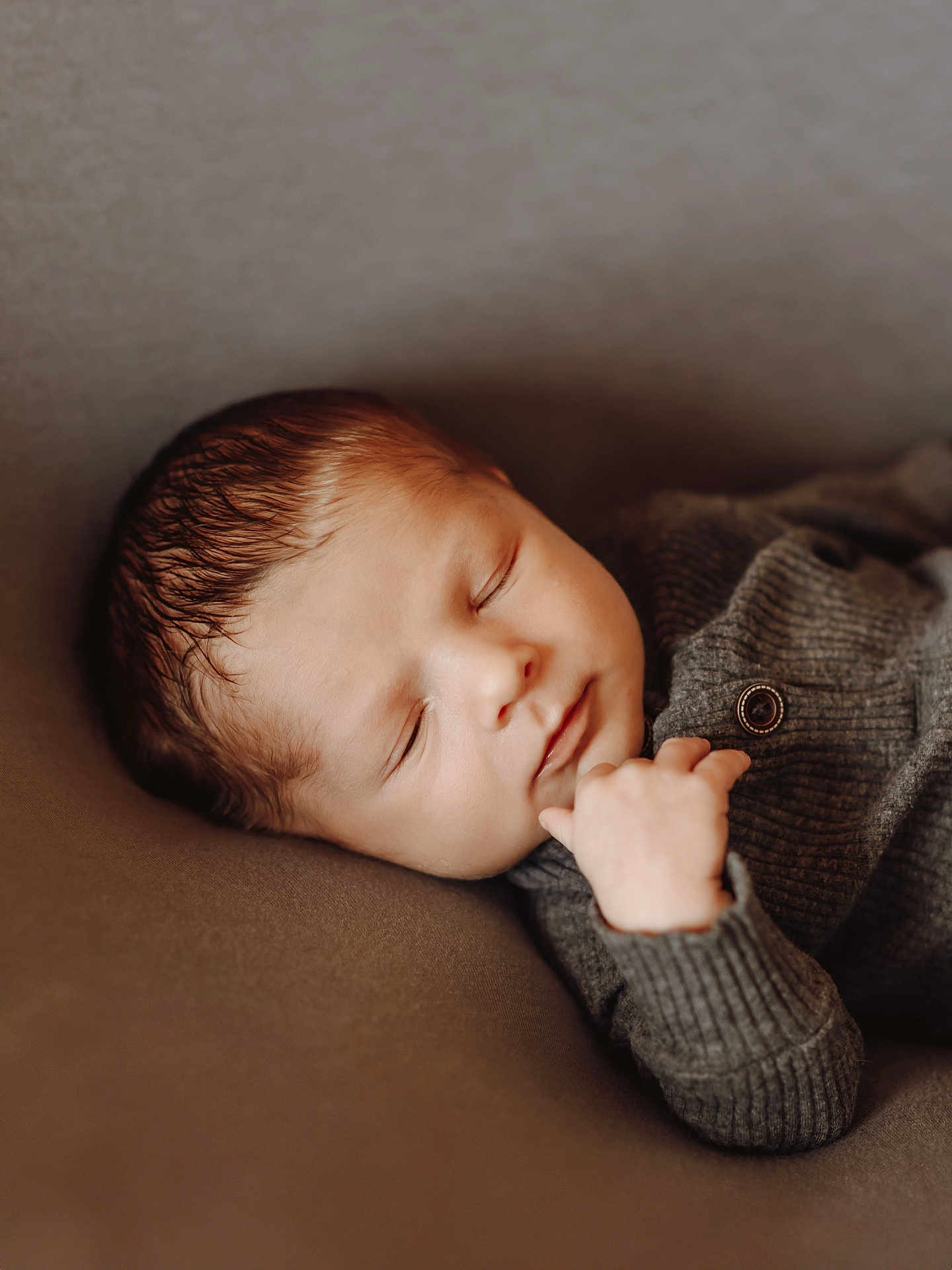 Resyn is registered to the contest to win money with this photo: baby, sleeping, infant, face, hand, clothing, knitwear, cozy, peaceful, portrait, newborn, soft, brown, relaxation, cute, child, rest, closeup, warm, comfort