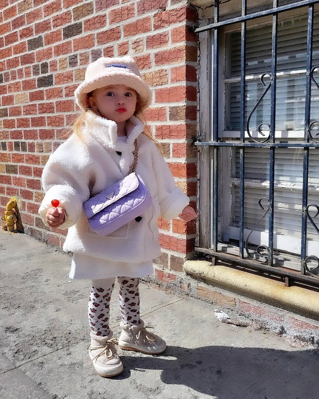 Gabriela joined the competition — help win amazing prizes! brick, brickwork, costume, costume_hat, eye, fashion_accessory, fashion_design, formal_wear, fur, hat, headgear, headwear, human_leg, outerwear, pattern, person, sitting, sleeve, sun_hat, uniform