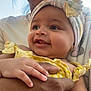 Jasmine is registered to the contest to win money with this photo: baby, adult, glasses, smile, yellow_clothing, headband, hand, face, portrait, outdoor, child, person, holding, happy, skin, closeup, infant, family, toddler, sunlight