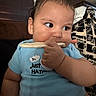 baby, blue_onesie, cheeks, child, couch, cracker, curious, cute, expression, face, food, hand, home, indoor, infant, person, pillow, sitting, snack, toddler
