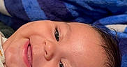Dylan joined the competition — help win amazing prizes! baby, smiling, face, blanket, blue, white, dimples, happy, infant, person, portrait, closeup, lying_down, cute, indoors, soft, warm, child, head, skin