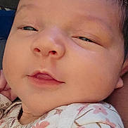 Zuri joined the competition — help win amazing prizes! baby, closeup, face, infant, sleepy, smile, floral, clothing, cute, skin, head, child, young, newborn, portrait, soft, warm, peaceful, indoors, expression