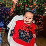 Deonni joined the competition — help win amazing prizes! baby, child, christmas_tree, presents, holiday, festive_clothing, red_outfit, bow_headband, smiling, indoor, decorations, christmas_lights, happy, chair, floor, black_shoes, jewelry, celebration, holiday_season, cute