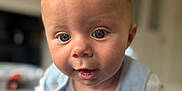 Oliver is registered to the contest to win money with this photo: baby, infant, child, face, eyes, mouth, hand, blanket, clothing, indoor, portrait, cute, expression, skin, head, toddler, focus, soft_light, texture, blue