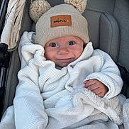 Oliver joined the competition — help win amazing prizes! baby, smile, hat, pom_poms, knitted_sweater, blanket, stroller, cute, child, warm_clothing, cozy, infant, blue_eyes, happy, portrait, indoor, soft_texture, clothing, person, baby_face