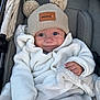baby, smile, hat, pom_poms, knitted_sweater, blanket, stroller, cute, child, warm_clothing, cozy, infant, blue_eyes, happy, portrait, indoor, soft_texture, clothing, person, baby_face