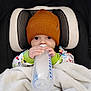 baby, infant, bottle, milk, hat, knit_hat, blanket, car_seat, child, feeding, cute, clothing, indoors, cozy, warm, sleepy, young, face, hands, person