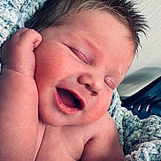 Brian joined the competition — help win amazing prizes! baby, newborn, infant, sleeping, smiling, face, cheek, hand, spiky_hair, hair, mouth_open, cozy_blanket, soft_texture, closeup, portrait, skin, peaceful, relaxed, indoor, nursery