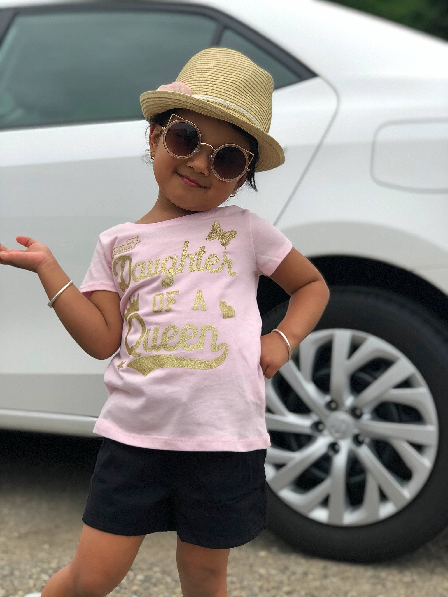 Prisha is registered to the contest to win money with this photo: auto_part, car, child, clothing, cool, eyewear, family_car, fashion_accessory, fedora, glasses, hat, headgear, headwear, joy, person, shorts, street_fashion, sun_hat, sunglasses, t_shirt