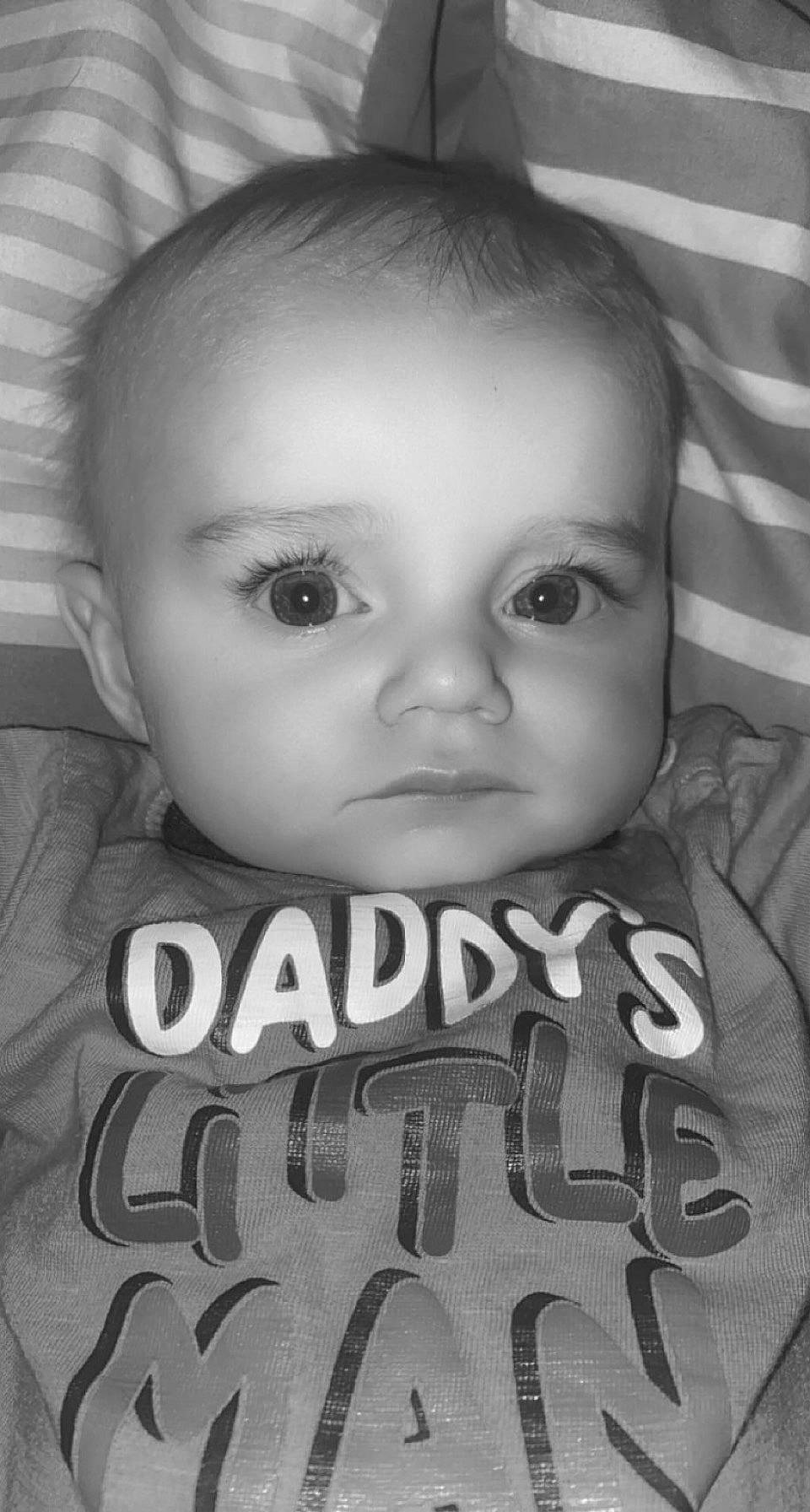 Shane is registered to the contest to win money with this photo: black_and_white, cheek, chin, eyebrow, eyelash, facial_expression, flash_photography, forehead, hairstyle, human, lip, mammal, mouth, nose, organ, person, product, skin, sleeve, standing