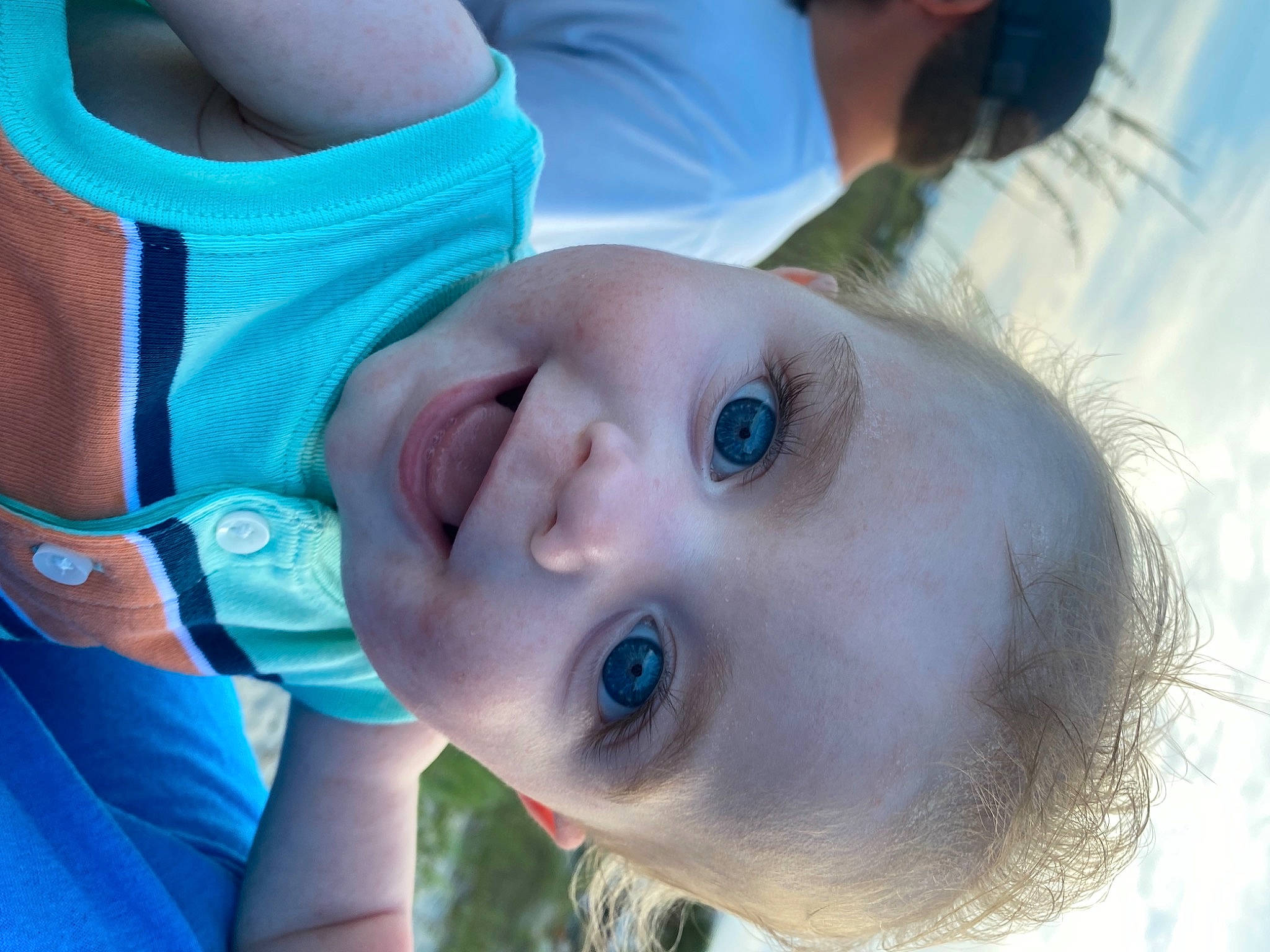 Shane is registered to the contest to win money with this photo: cheek, eyebrow, eyelash, facial_expression, gesture, happy, iris, joy, lip, mouth, neck, nose, organ, person, plant, skin, smile, toddler, tree, water