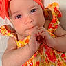 baby, infant, headband, orange, colorful_clothing, floral_pattern, cute, hands, portrait, closeup, skin, eyes, face, lying_down, child, apparel, summer_clothing, adorable, soft_light, expression