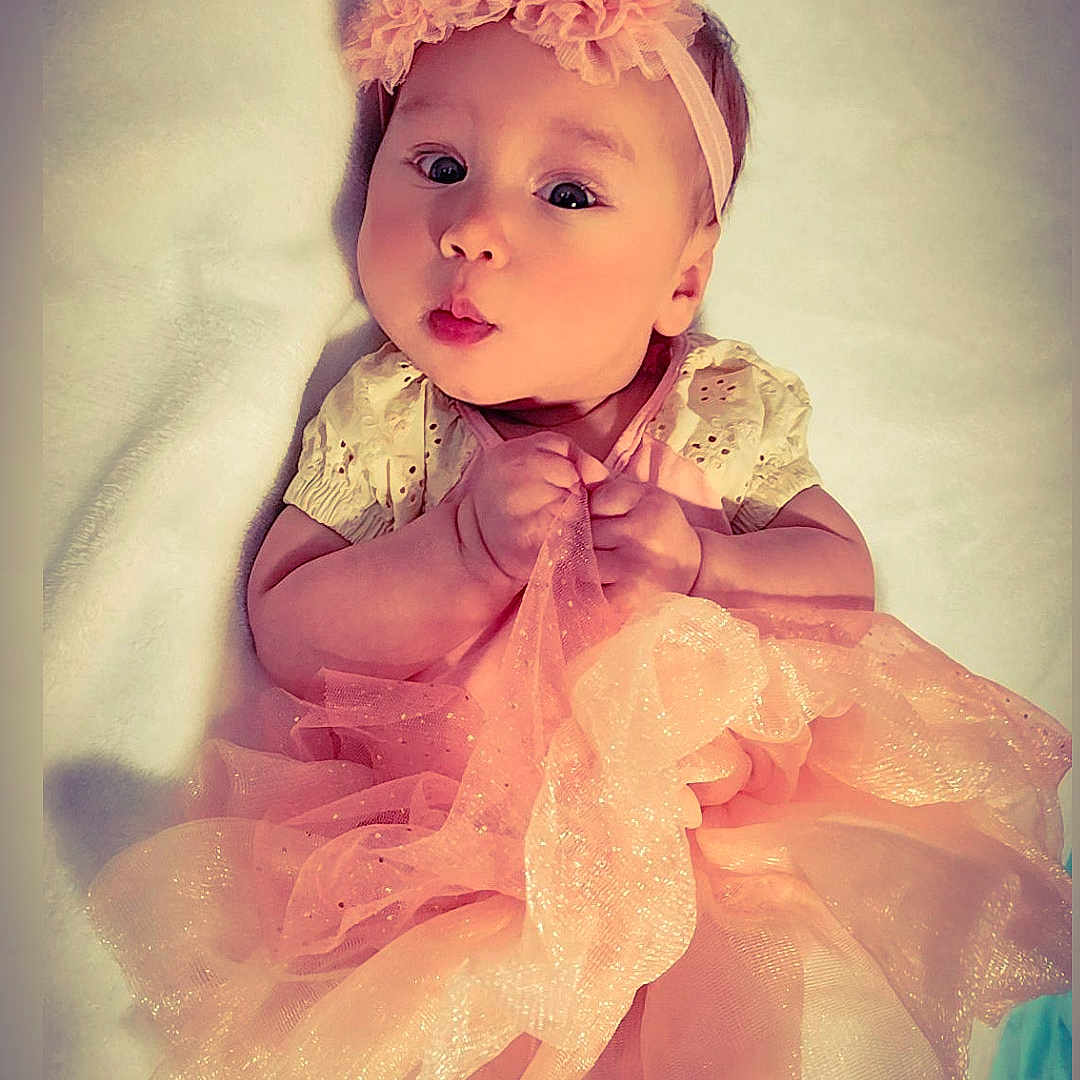 Alexa Sanchez is registered to the contest to win money with this photo: accessories, baby, bodypart, bonnet, cap, clothing, costume, dress, face, finger, formalwear, hand, hat, head, headband, newborn, person, photography, portrait, toy
