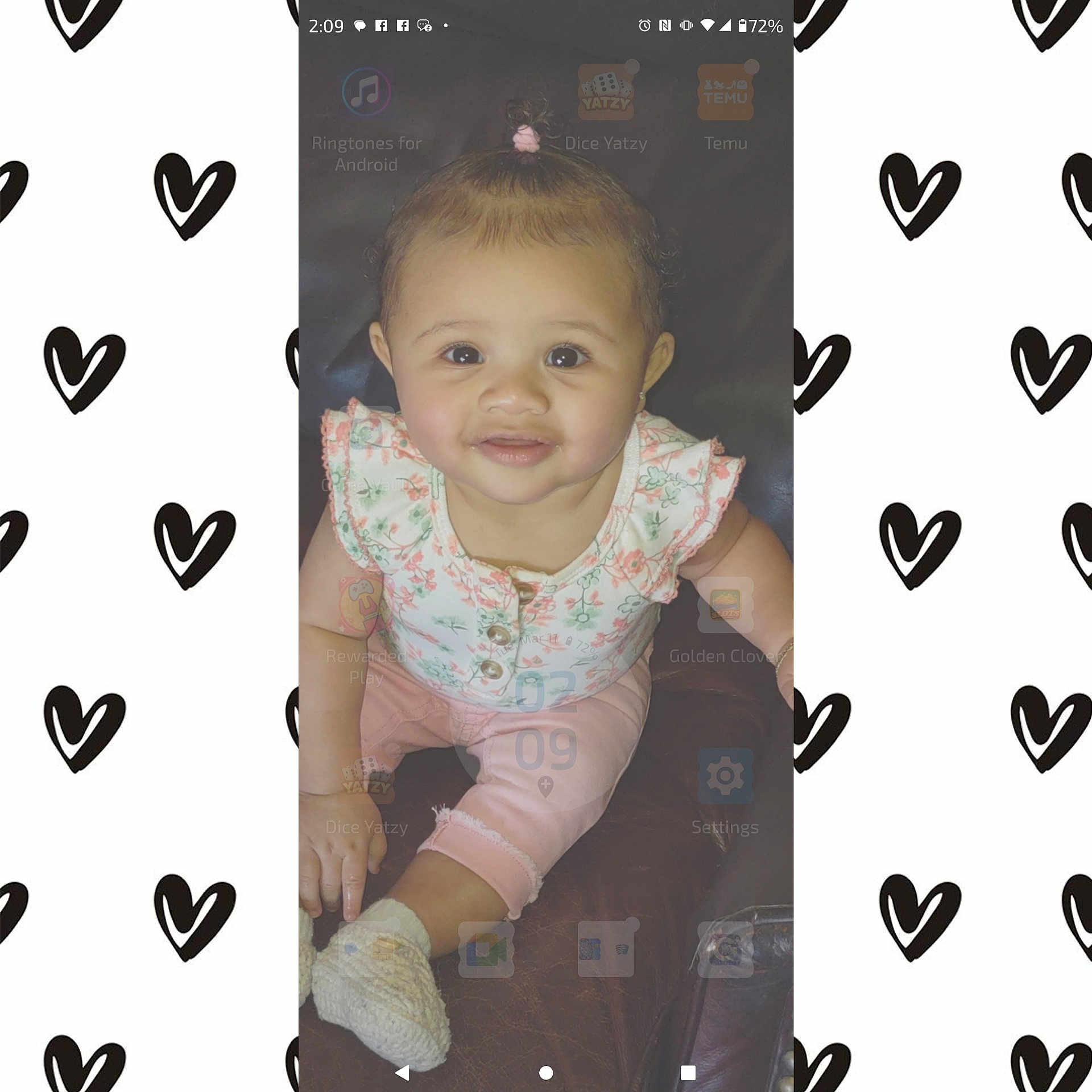 Ezzie is registered to the contest to win money with this photo: app_icons, baby, child, cute, dark_background, digital_overlay, face, floral_clothing, hair_tie, happy, indoor, infant, phone_screenshot, pink_pants, portrait, sitting, smiling, topknot, white_booties, young_child