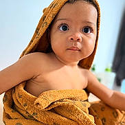 Elynn participe au concours pour gagner de l'argent avec cette photo : baby, child, towel, orange, hooded_towel, curious, indoor, portrait, skin, face, eyes, expression, cute, young, infant, soft_texture, blanket, wrapped, person, warm