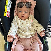 Victoire participe au concours pour gagner de l'argent avec cette photo : baby, car_seat, blanket, sunglasses, pink_clothing, sweater, infant, child, face, blue_eyes, cute, indoors, seat, knitted_blanket, person, apparel, cozy, fashion, adorable, portrait
