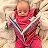 Victoire participe au concours pour gagner de l'argent avec cette photo : baby, child, book, reading, pink_clothing, corduroy, toy, giraffe_toy, blanket, soft_texture, indoor, cute, portrait, infant, playful, cozy, person, sitting, curious, colorful
