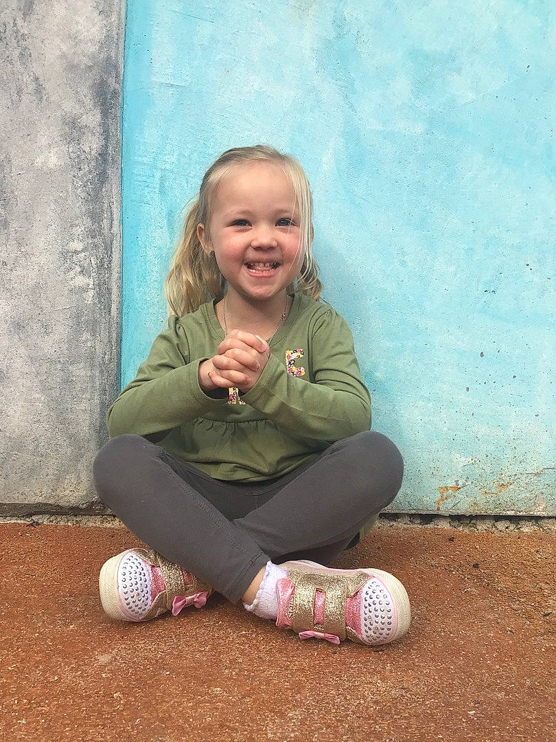 Scarlett joined the competition — help win amazing prizes! blond, child, eye, face, foot, fun, grass, happy, head, human_leg, joy, knee, leg, leisure, people_in_nature, person, pink, sitting, smile, standing