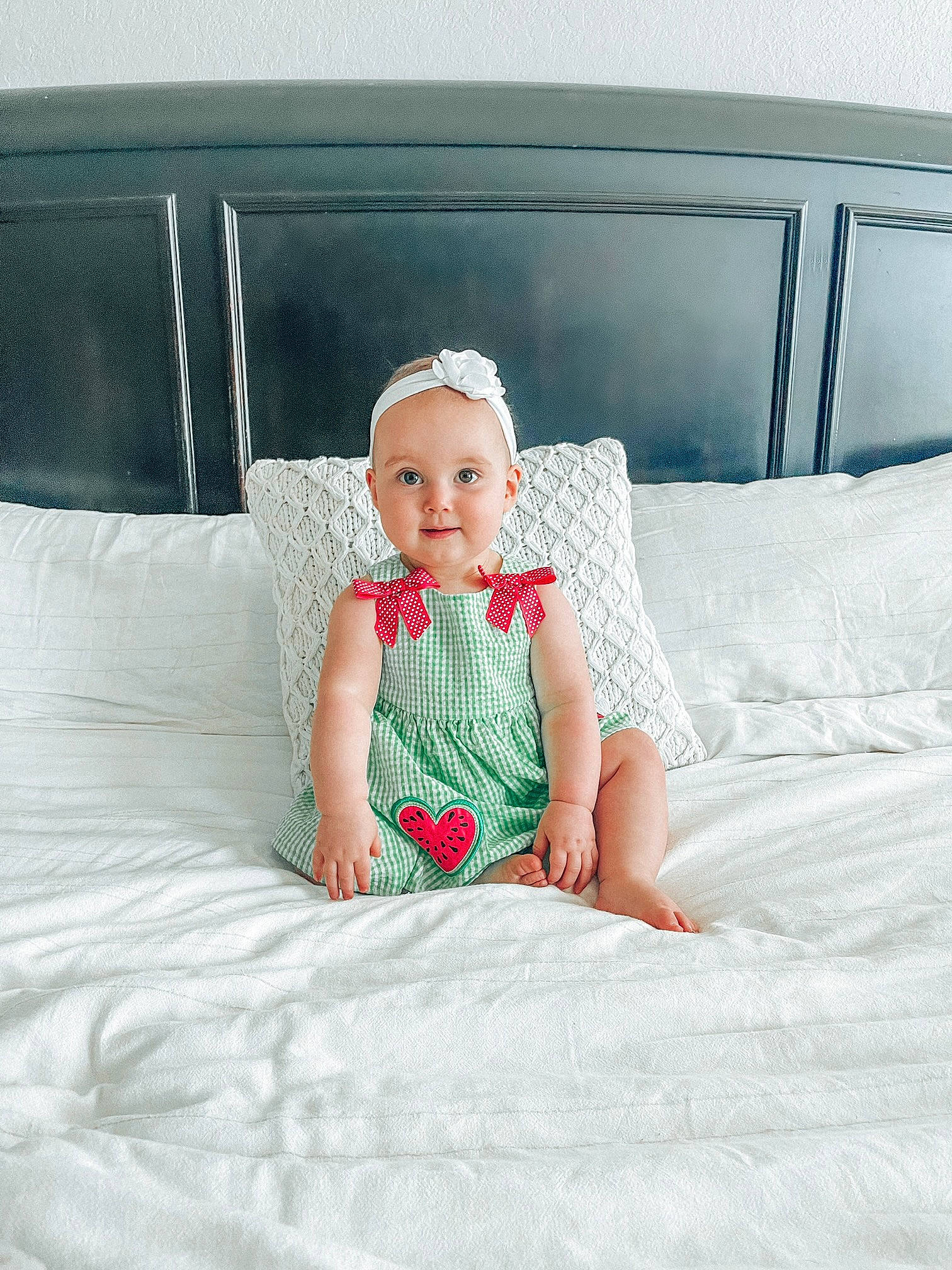 Leighton is registered to the contest to win money with this photo: baby_toddler_clothing, comfort, couch, day_dress, dress, eye, face, hair, happy, head, human_leg, linens, magenta, pattern, person, pink, skin, sleeve, smile, textile