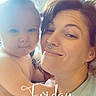 November is registered to the contest to win money with this photo: baby, adult, selfie, smile, nose_ring, indoor, portrait, child, curly_hair, light, handwritten_note, text_overlay, diaper, affection, family, casual, happy, skin, person, closeup