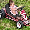 Mötley is registered to the contest to win money with this photo: casual, child, cute, daylight, funny_face, girl, go_kart, grass, greenery, happy, lawn, outdoor, pink_clothing, play, playful, seat, small_vehicle, steering_wheel, summer, toy