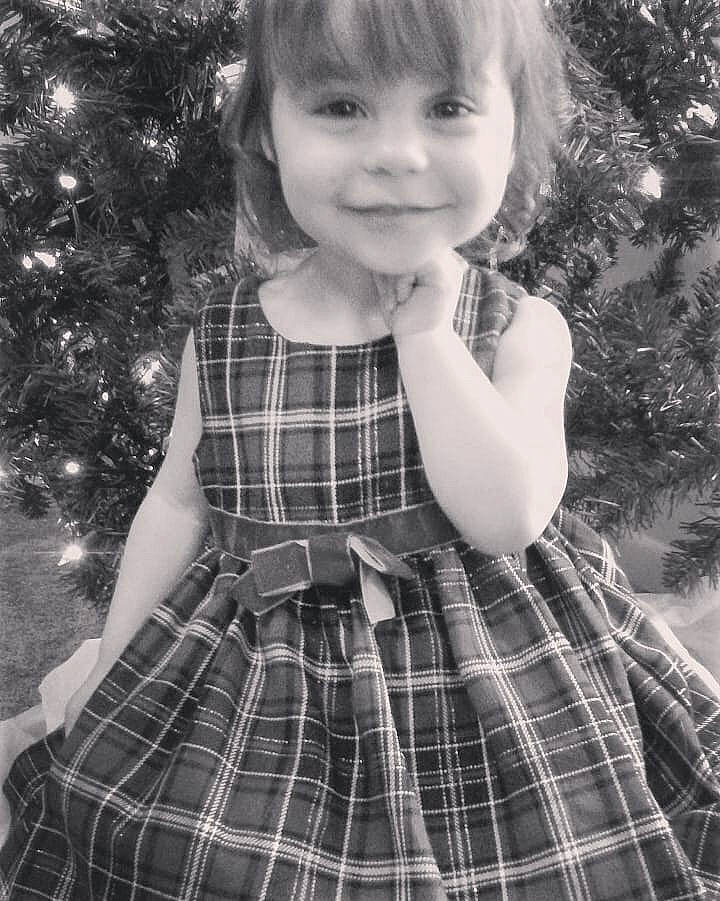 Vivian is registered to the contest to win money with this photo: black_and_white, child, child_model, clothing, design, dress, joy, monochrome, pattern, person, photography, plaid, smile, style, tartan, textile, toddler, tree