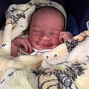 Arlo is registered to the contest to win money with this photo: baby, blanket, smile, sleeping, infant, soft_texture, cozy, wrapped, cute, newborn, peaceful, child, face, hand, comfort, warm, portrait, resting, indoors, clothing