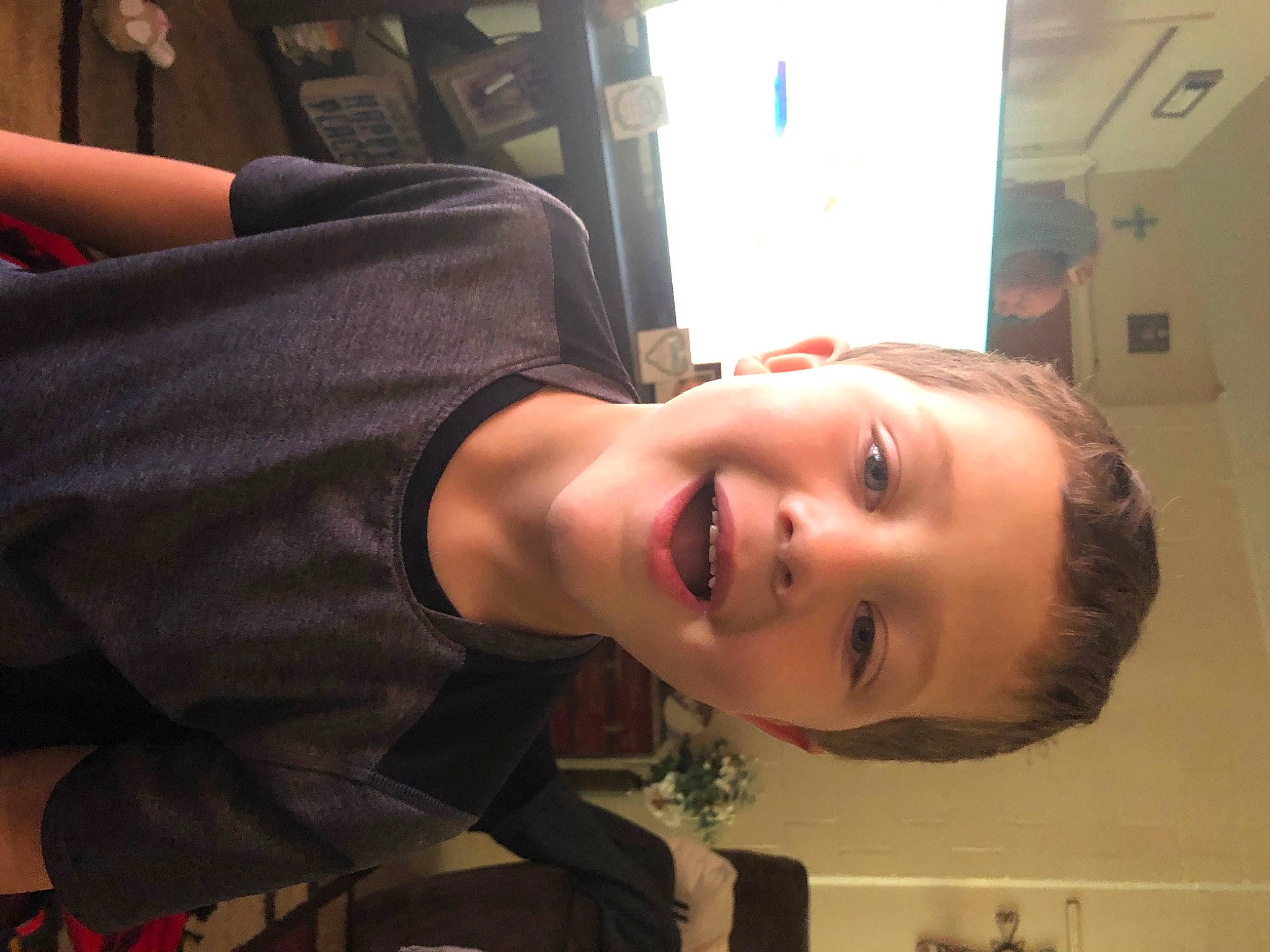 King is registered to the contest to win money with this photo: black_hair, cheek, chest, child, eye, eyelash, flash_photography, forehead, formal_wear, fun, hair_coloring, happy, jaw, joint, mouth, neck, nose, person, room, sitting