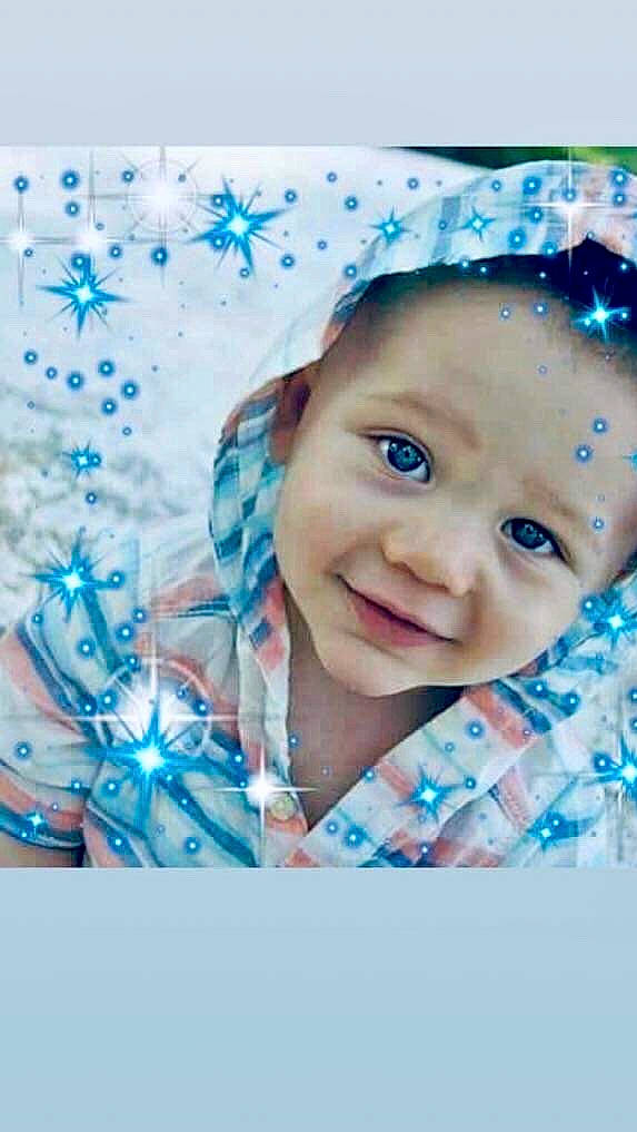 King is registered to the contest to win money with this photo: aqua, azure, baby, baby_toddler_clothing, cap, cheek, child, electric_blue, event, fashion_accessory, fun, happy, iris, pattern, people_in_nature, person, portrait_photography, sleeve, smile, textile