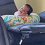 Adaly is registered to the contest to win money with this photo: baby, child, smiling, pillow, animal_pattern, chair, recliner, furniture, indoor, happy, resting, cute, comfort, portrait, infant, home, seat, colorful, soft_light, relaxation