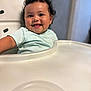 Victoria joined the competition — help win amazing prizes! baby, child, smile, curly_hair, high_chair, happy, indoor, person, cute, infant, sitting, clothing, face, earrings, tongue, table, skin, young, portrait, bright