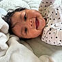 Victoria is registered to the contest to win money with this photo: baby, blanket, child, closeup, clothing, cozy, cute, face, happy, heart_pattern, indoors, infant, lying_down, person, portrait, skin, smile, soft_texture, toddler, white_blanket